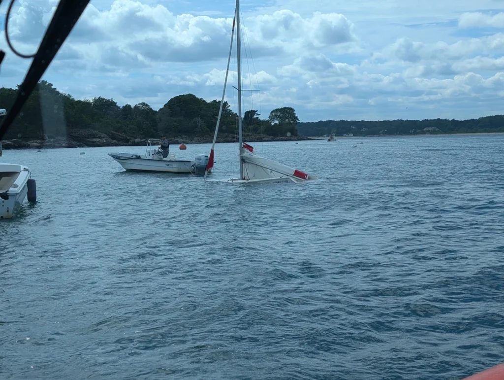 Small sailboat in process of sinking